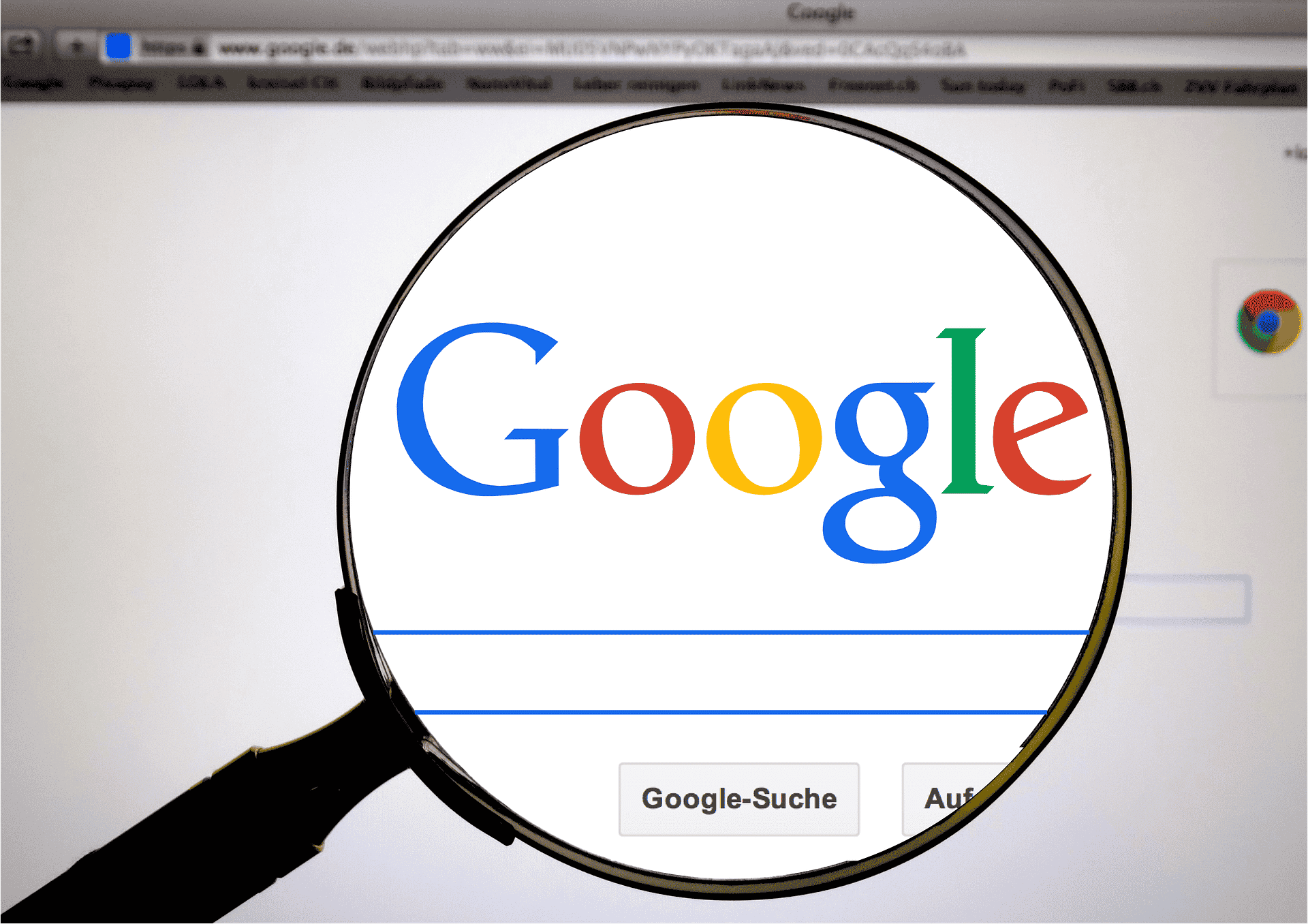magnifying glass placed over Google search home page in Safari browser