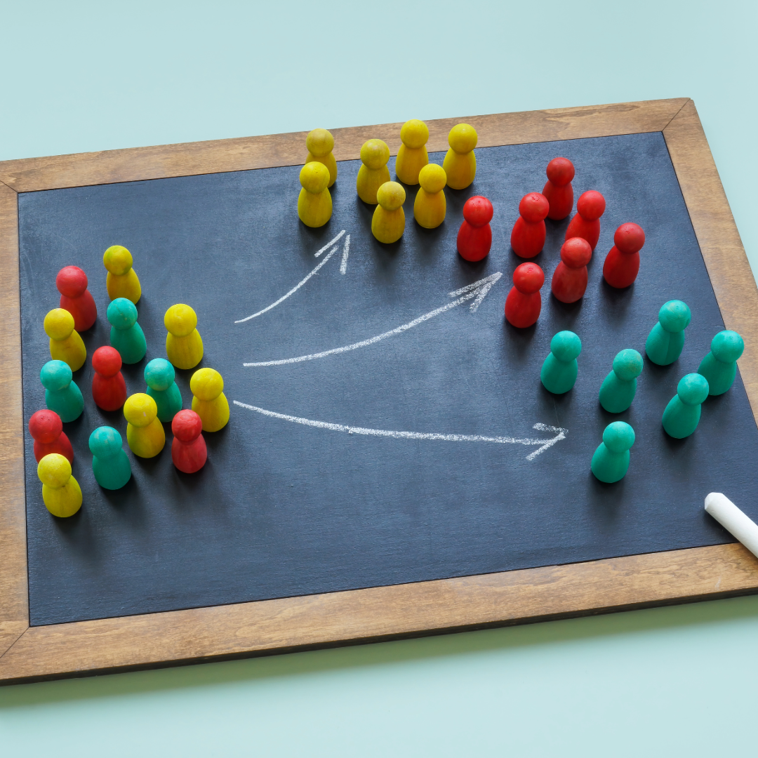 wood framed chalkboard with colored wooden pegs and white arrows showing siloed teams